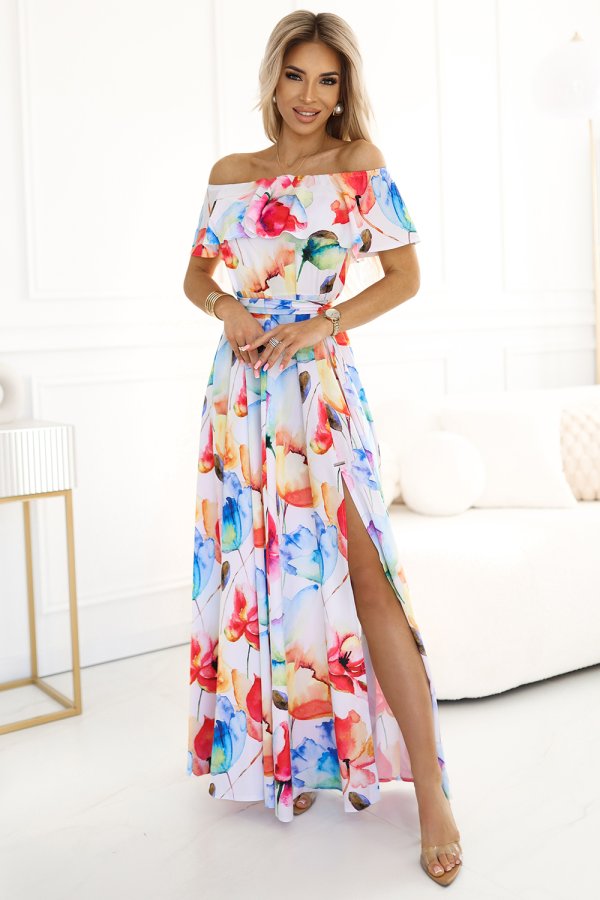 The image features a vibrant, off-the-shoulder maxi dress adorned with a colorful floral pattern. The dress has a flowing design with a high slit, perfect for a stylish and elegant look.