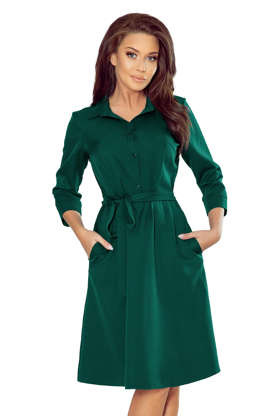 A stylish green dress with a button-up front and a matching waist tie, featuring long sleeves and convenient side pockets. The dress offers a classic and elegant look, perfect for both casual and formal occasions.
