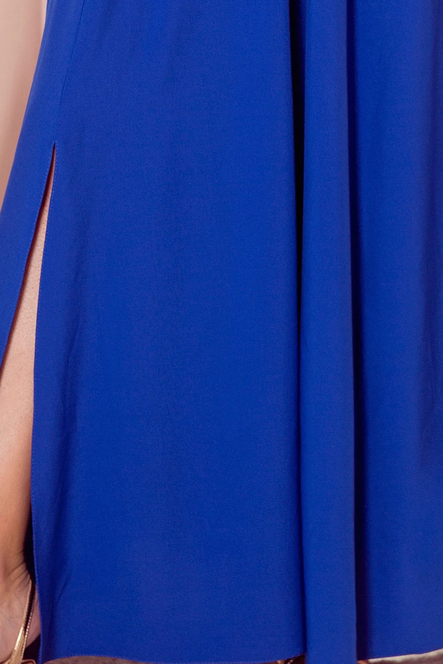 A vibrant blue dress featuring a stylish side slit for an elegant touch. The fabric drapes beautifully, offering a sophisticated and modern look.