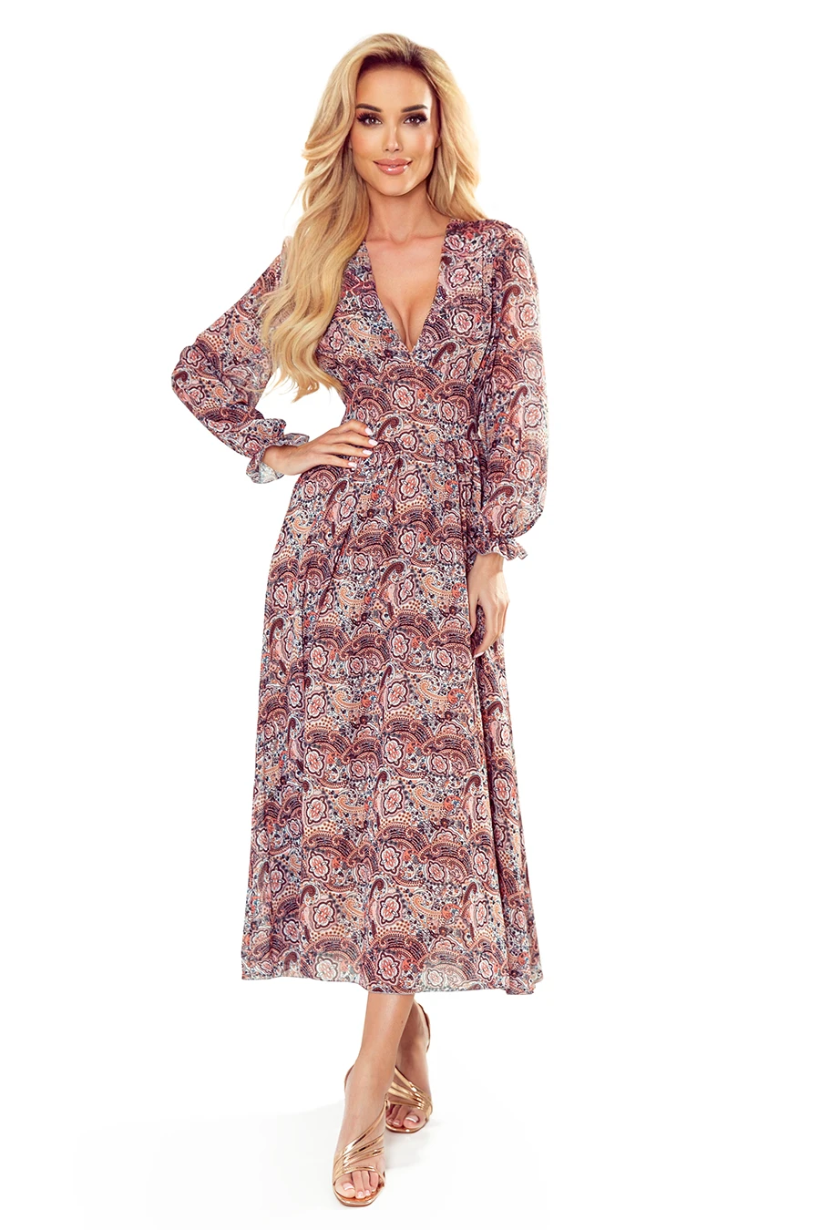 A long, flowing dress with a vibrant paisley pattern and a deep V-neckline. The dress features long sleeves and a fitted waist, creating an elegant silhouette.