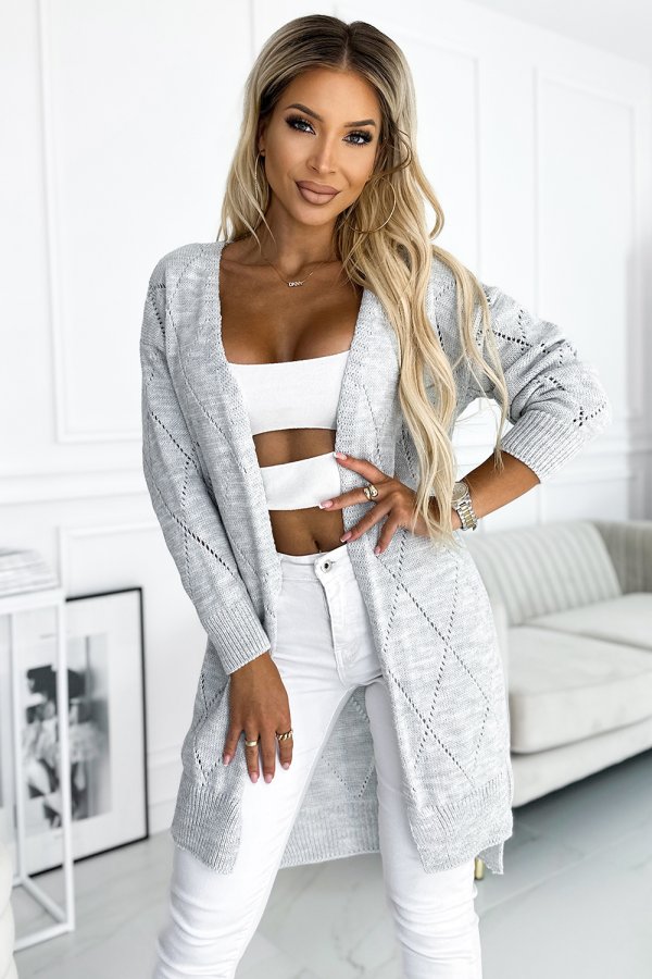 The image features a stylish, light gray knit cardigan with a diamond pattern, perfect for layering. It is paired with a white crop top and white pants, creating a chic and modern look.