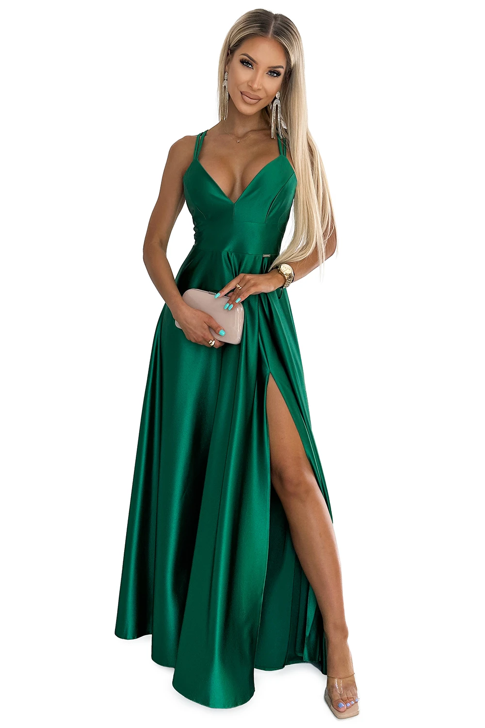 A stunning emerald green evening gown with a deep V-neckline and a high slit, perfect for elegant occasions. The dress is complemented by delicate straps and a flowing silhouette, adding a touch of sophistication.