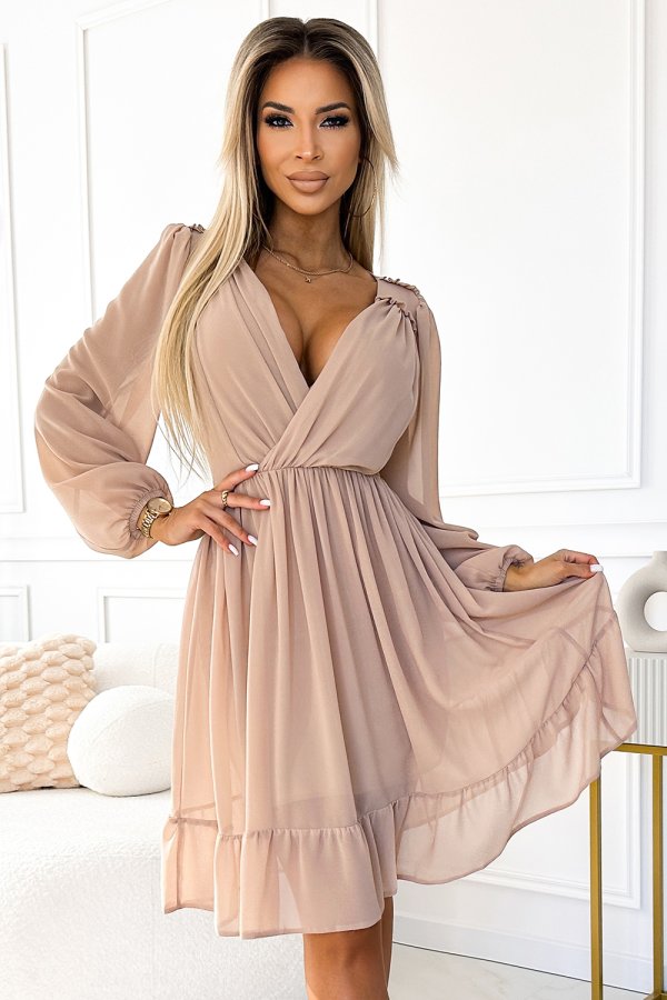 The image features a stylish, long-sleeved beige dress with a flowing, ruffled hem and a flattering wrap design. The dress exudes elegance and is perfect for both casual and formal occasions.