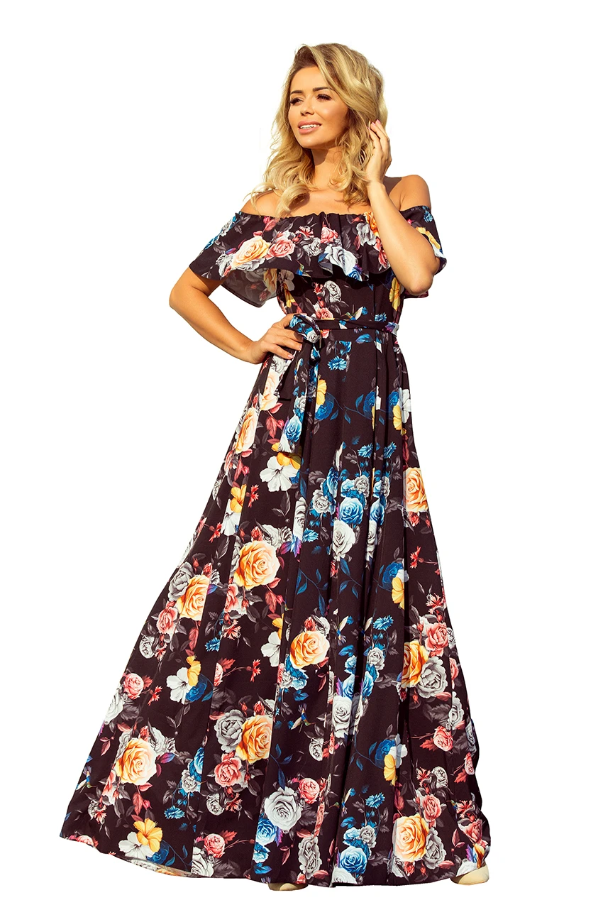 A long, off-the-shoulder floral dress features a vibrant pattern of colorful roses on a dark background. The dress is elegantly designed with a ruffled neckline and a flowing silhouette, perfect for a summer occasion.