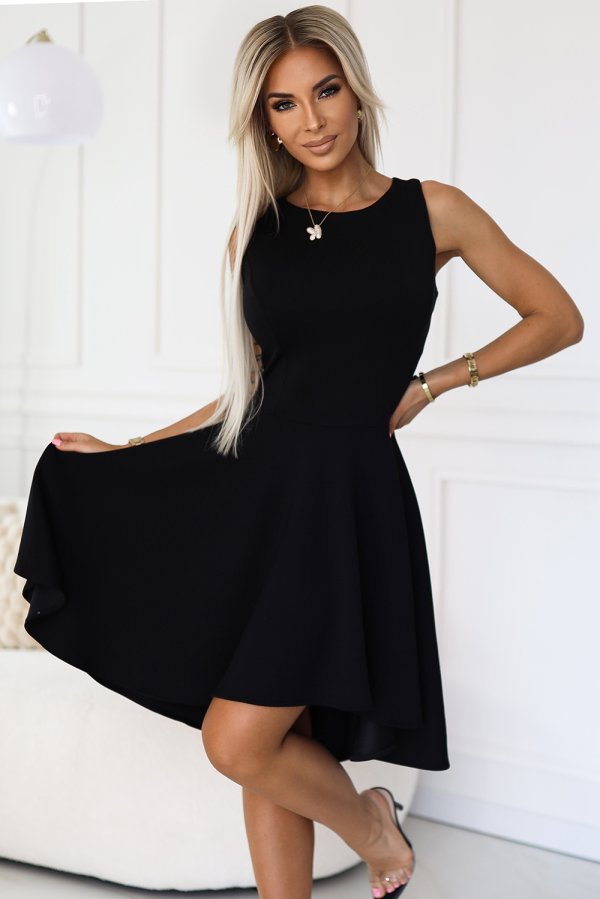 A woman is wearing a stylish black sleeveless dress with a flared skirt, perfect for both casual and formal occasions. The dress is complemented by elegant accessories, adding a touch of sophistication to the overall look.