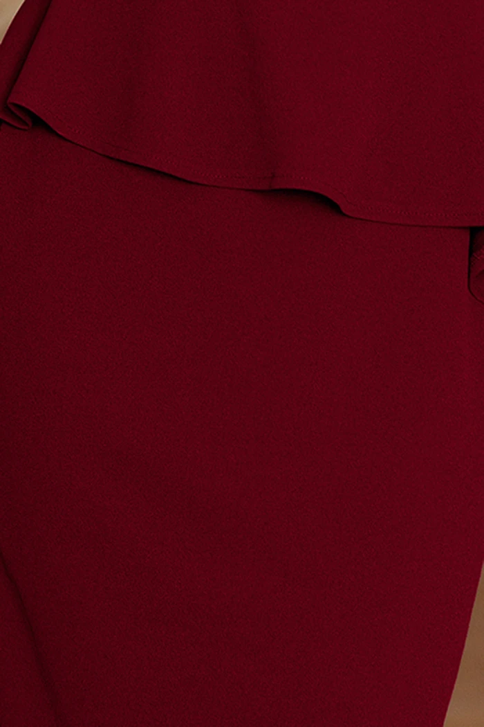 A close-up of a deep red fabric showcases its smooth texture and rich color. The material appears to be part of a garment with a layered design.