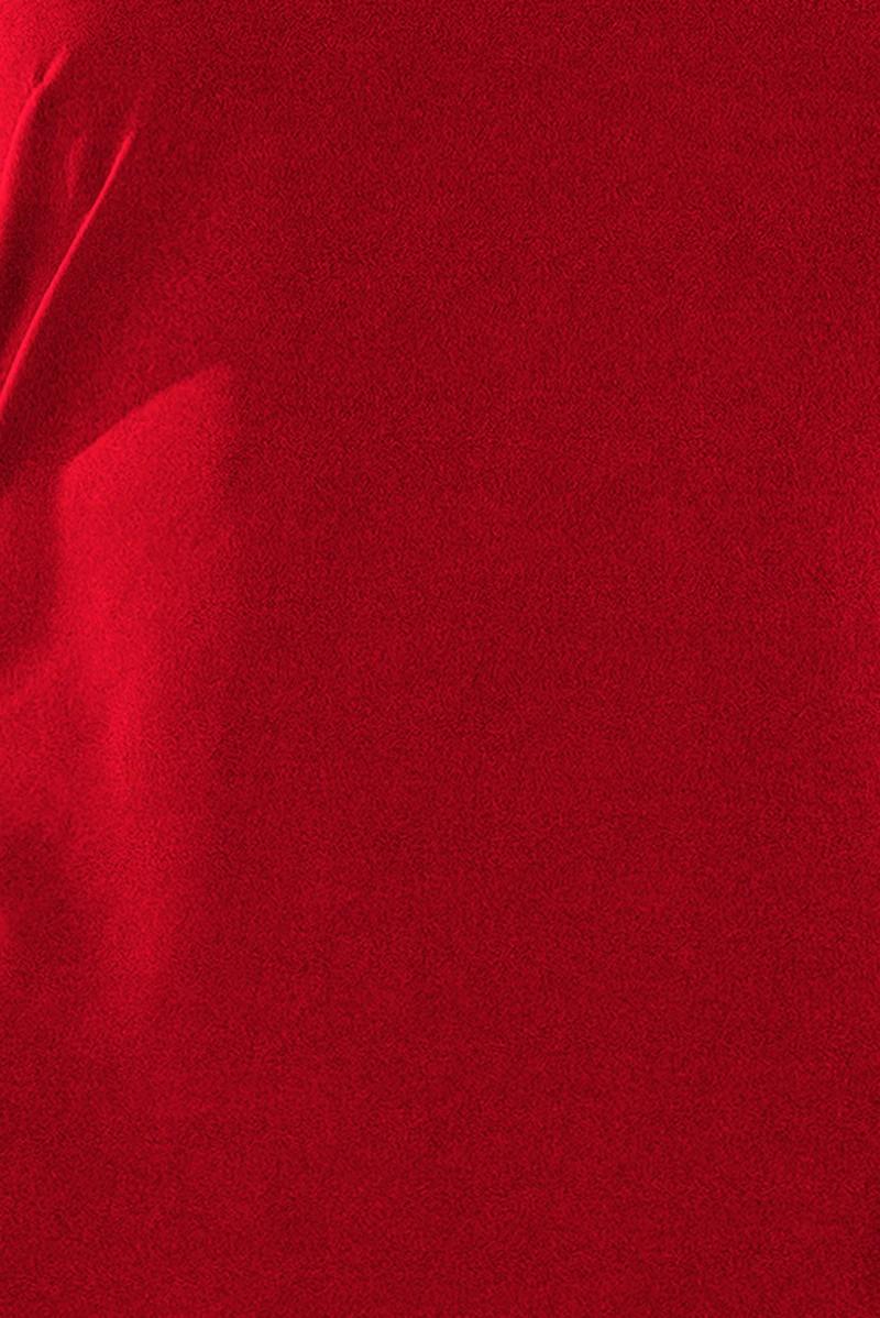 A vibrant red fabric with a soft, velvety texture is shown in close-up. The material appears smooth and luxurious, ideal for creating elegant garments or upholstery.