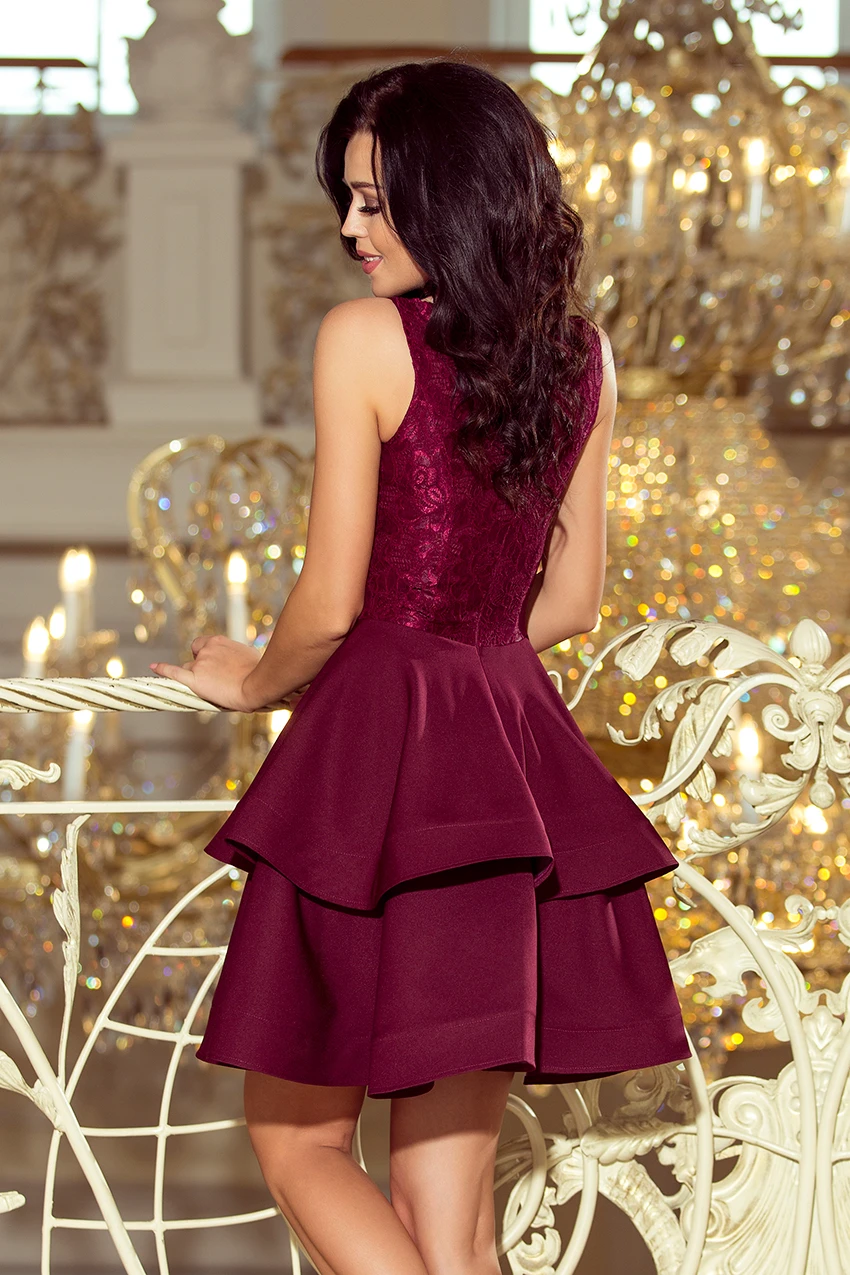 The image features an elegant burgundy dress with a lace bodice and a layered, flared skirt. The dress exudes sophistication, perfect for formal occasions or evening events.
