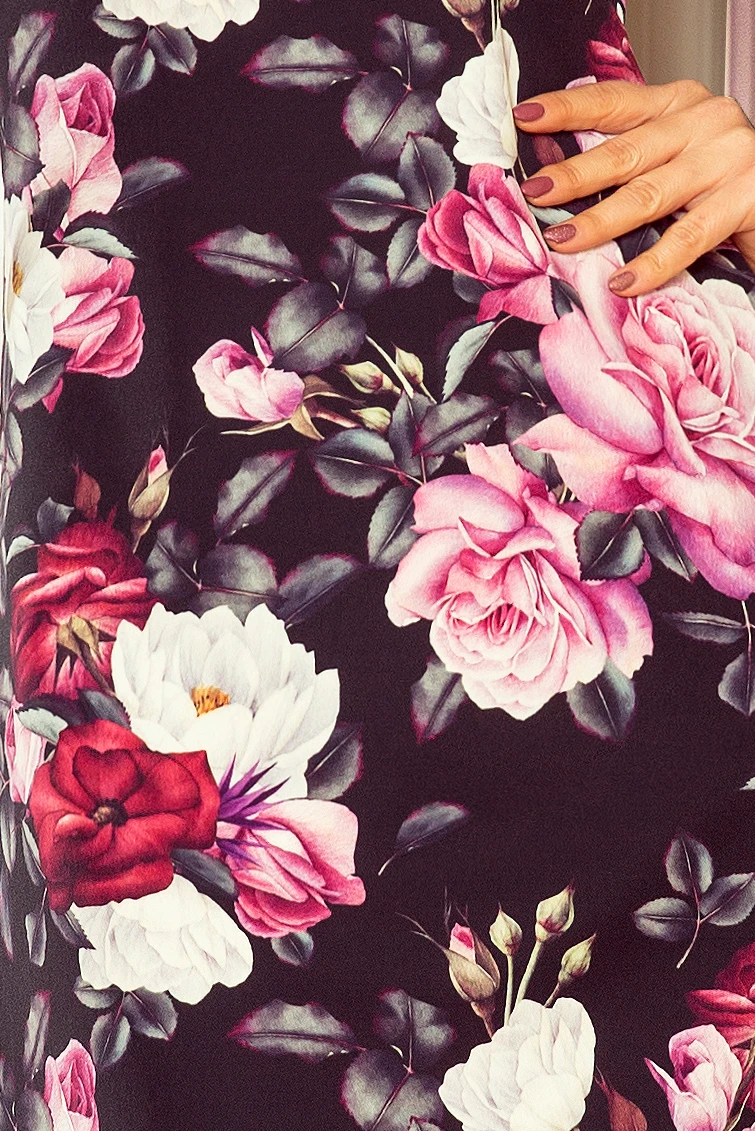 The image showcases a fabric with a vibrant floral pattern featuring pink, red, and white flowers against a dark background. The design is elegant and eye-catching, perfect for a stylish garment.