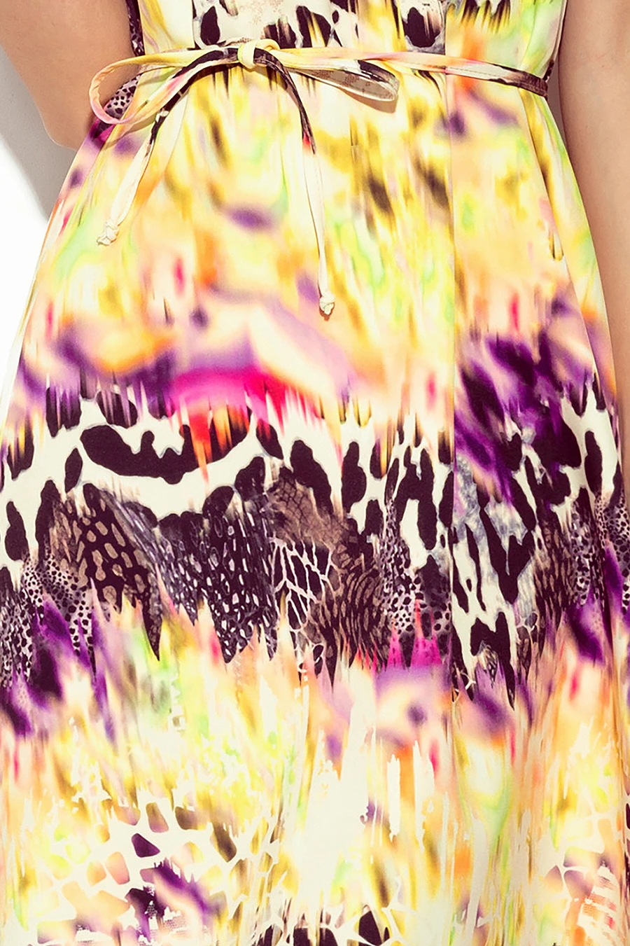 A vibrant dress featuring a colorful abstract pattern with animal print accents. The design includes a delicate waist tie for added elegance.