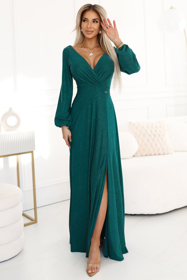A long, elegant emerald green dress with a deep V-neckline and a high slit, perfect for formal occasions. The dress features long sleeves and a shimmering fabric that adds a touch of glamour.
