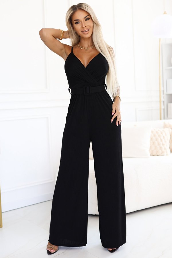 The woman in the photo is wearing a sleek black jumpsuit, highlighting its elegant silhouette and comfortable fit. The model showcases how this stylish jumpsuit can be both chic and versatile for any occasion.