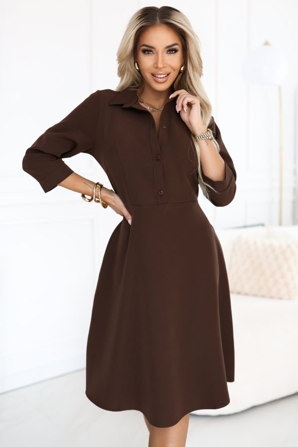 The image showcases a stylish brown dress featuring long sleeves and a tied waist design, perfect for both casual and formal occasions. This brown dress elegantly drapes, adding a sophisticated touch to any wardrobe collection.