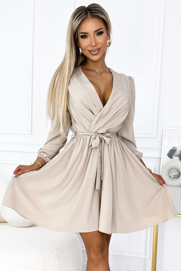 A stylish beige wrap dress with long sleeves and a tie waist, perfect for elegant occasions. The dress features a flattering V-neckline and a flowing skirt for a sophisticated look.