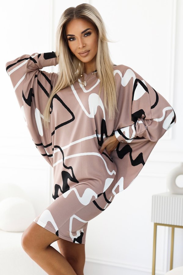 A stylish dress featuring an abstract pattern in shades of beige, black, and white, perfect for a modern and chic look. The loose-fitting design offers comfort and elegance, making it suitable for various occasions.