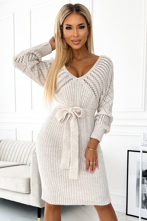 The image features a stylish beige knit dress with intricate patterns and a flattering waist tie. The dress combines elegance and comfort, making it perfect for both casual and formal occasions.