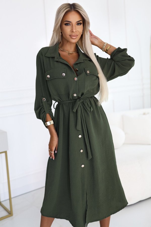 The woman in the photo is wearing a stylish olive green midi dress, perfect for both casual and formal occasions. The model showcases the dress's elegant flow and button details, highlighting its versatile design.