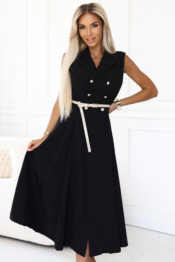 The woman in the photo is wearing a chic black midi dress, elegantly cinched at the waist with a slim belt. This stylish black dress flows gracefully, perfect for both casual and formal occasions.